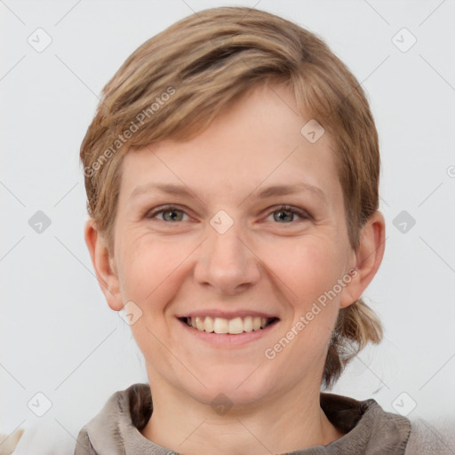 Joyful white young-adult female with medium  brown hair and grey eyes