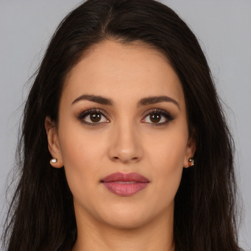 Joyful white young-adult female with long  brown hair and brown eyes