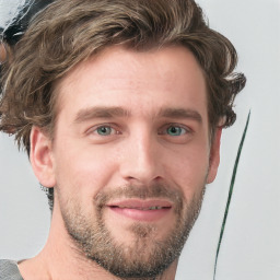 Joyful white young-adult male with short  brown hair and blue eyes