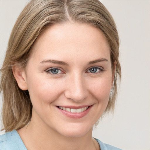 Joyful white young-adult female with medium  brown hair and blue eyes