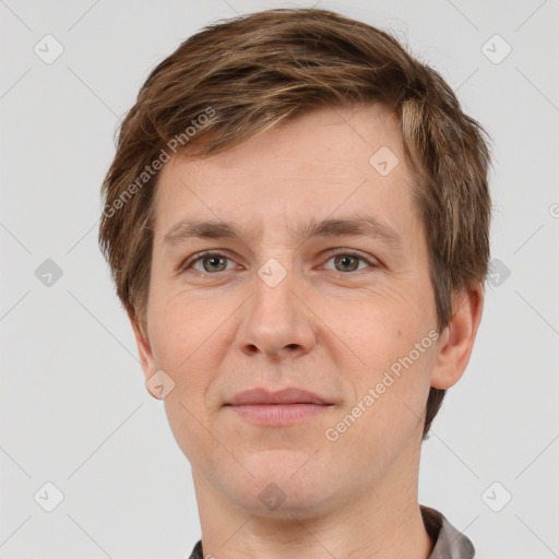 Joyful white adult male with short  brown hair and grey eyes