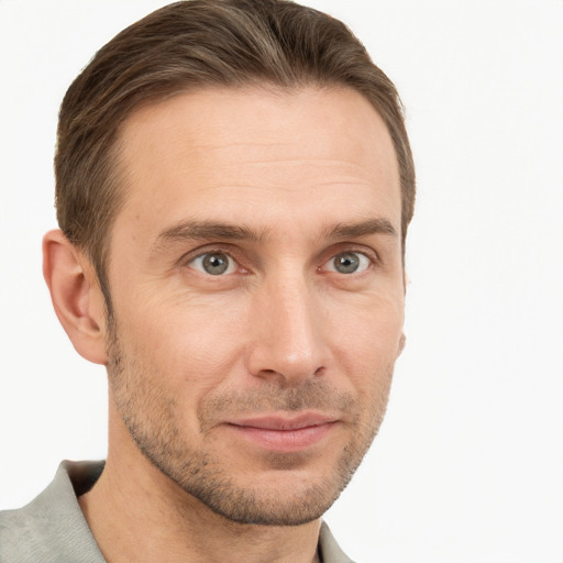 Joyful white adult male with short  brown hair and grey eyes