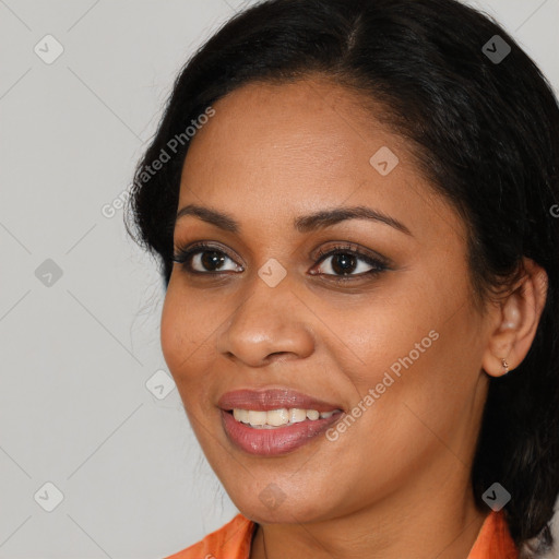 Joyful black young-adult female with medium  brown hair and brown eyes