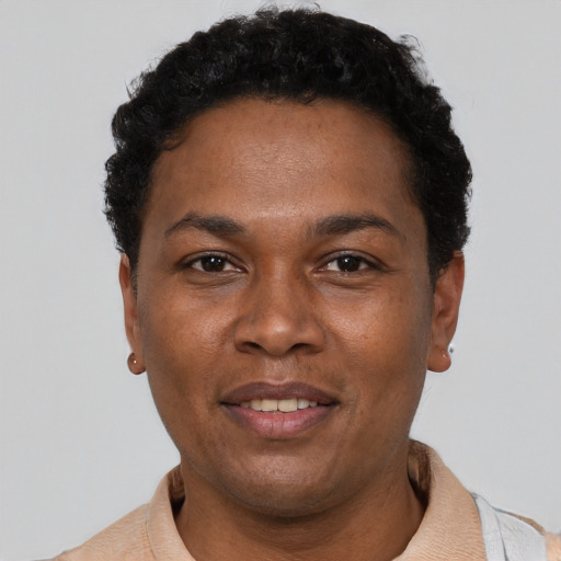 Joyful black adult male with short  black hair and brown eyes