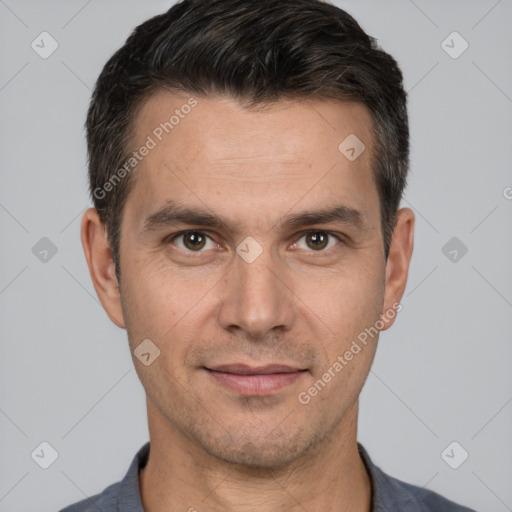 Joyful white adult male with short  black hair and brown eyes