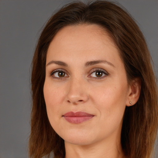 Joyful white adult female with long  brown hair and brown eyes