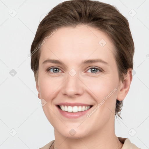 Joyful white young-adult female with short  brown hair and grey eyes