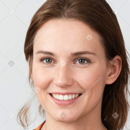 Joyful white young-adult female with medium  brown hair and grey eyes