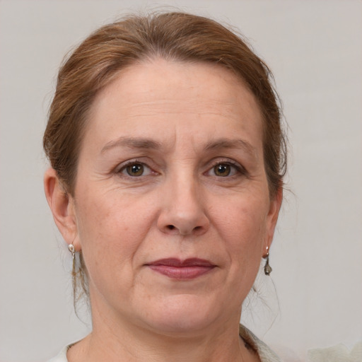 Joyful white adult female with medium  brown hair and grey eyes