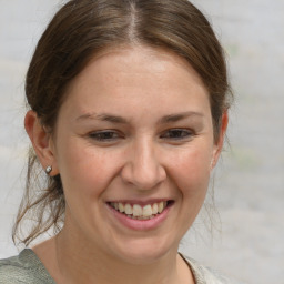 Joyful white young-adult female with medium  brown hair and grey eyes