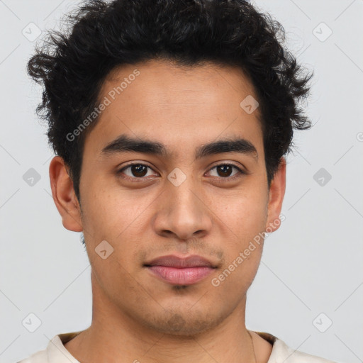 Joyful latino young-adult male with short  brown hair and brown eyes