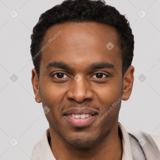 Joyful black young-adult male with short  brown hair and brown eyes