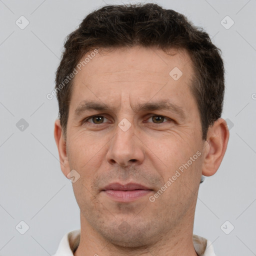 Joyful white adult male with short  brown hair and brown eyes