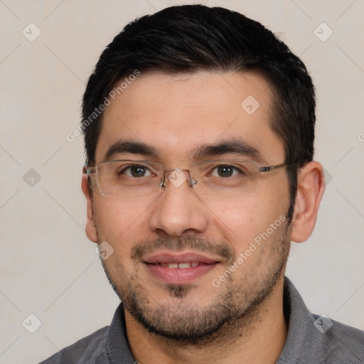 Joyful white young-adult male with short  black hair and brown eyes