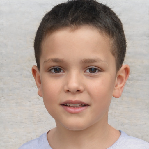 Joyful white child male with short  brown hair and brown eyes