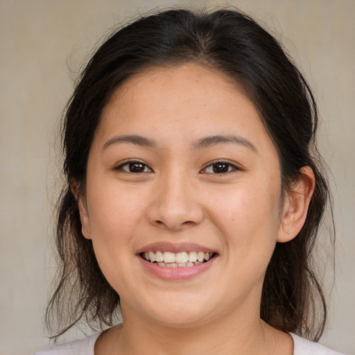 Joyful white young-adult female with medium  brown hair and brown eyes