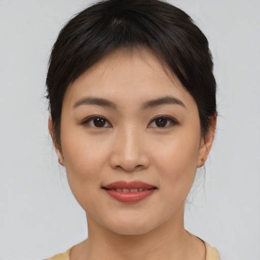 Joyful asian young-adult female with medium  brown hair and brown eyes