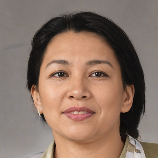 Joyful asian adult female with medium  brown hair and brown eyes