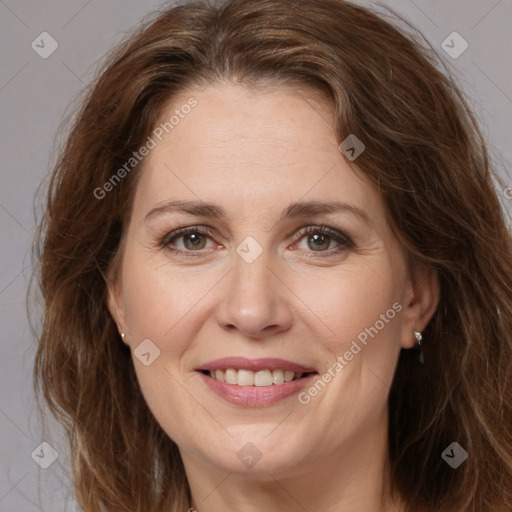 Joyful white adult female with long  brown hair and brown eyes