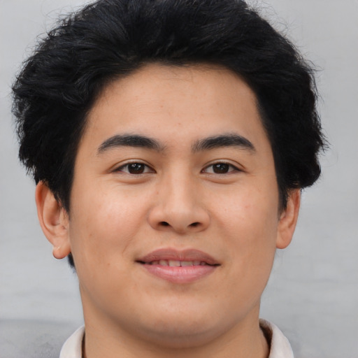 Joyful asian young-adult male with short  brown hair and brown eyes