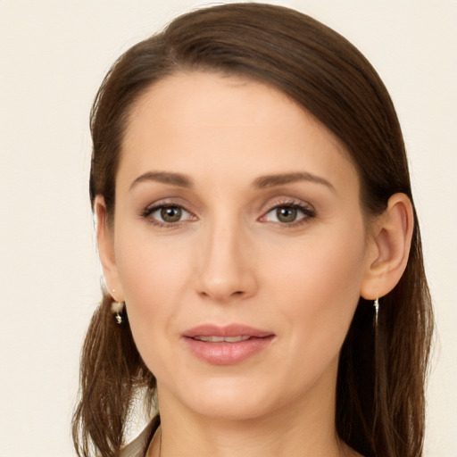 Joyful white young-adult female with long  brown hair and brown eyes