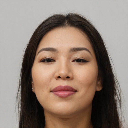 Joyful latino young-adult female with long  brown hair and brown eyes