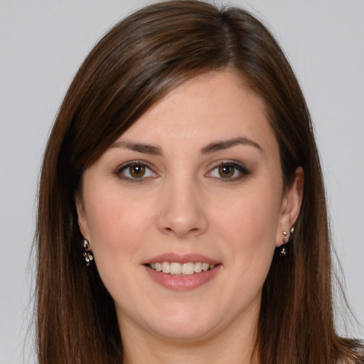 Joyful white young-adult female with long  brown hair and brown eyes