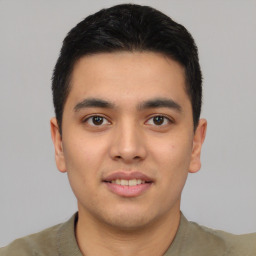 Joyful latino young-adult male with short  black hair and brown eyes