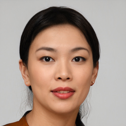 Joyful asian young-adult female with short  black hair and brown eyes