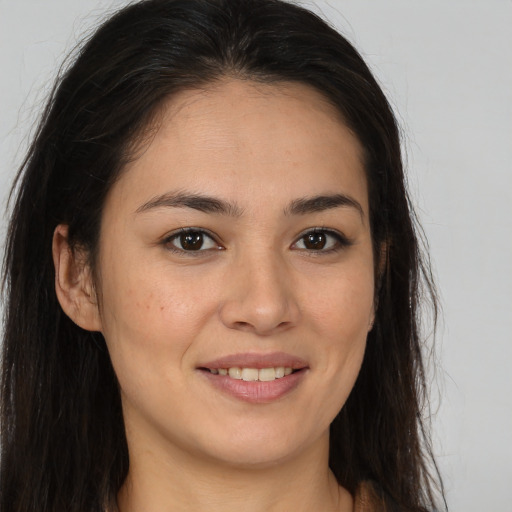 Joyful white young-adult female with long  brown hair and brown eyes