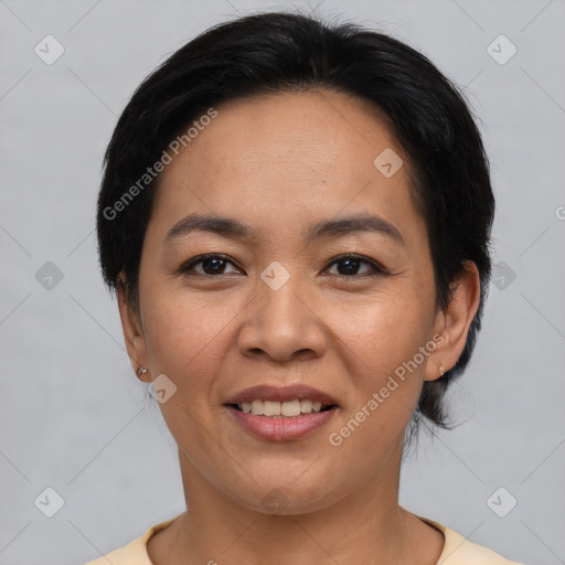 Joyful asian adult female with short  black hair and brown eyes