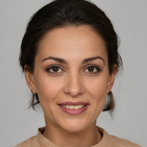 Joyful white young-adult female with medium  brown hair and brown eyes