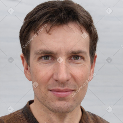 Joyful white adult male with short  brown hair and grey eyes