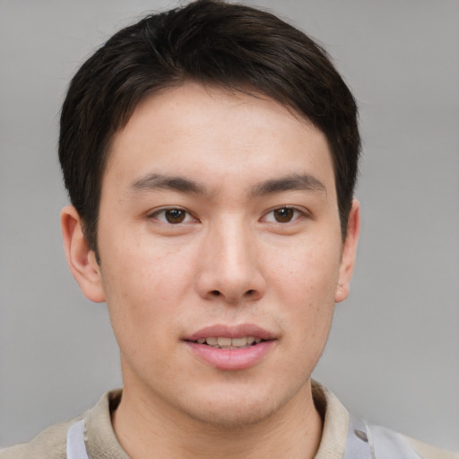 Joyful asian young-adult male with short  brown hair and brown eyes