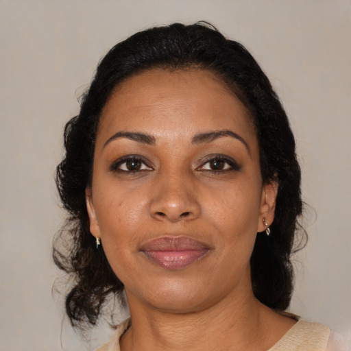 Joyful black young-adult female with medium  brown hair and brown eyes