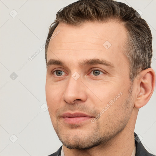 Joyful white adult male with short  brown hair and brown eyes