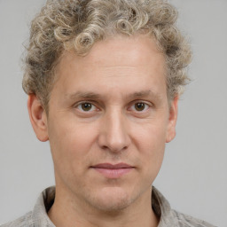 Joyful white adult male with short  brown hair and grey eyes