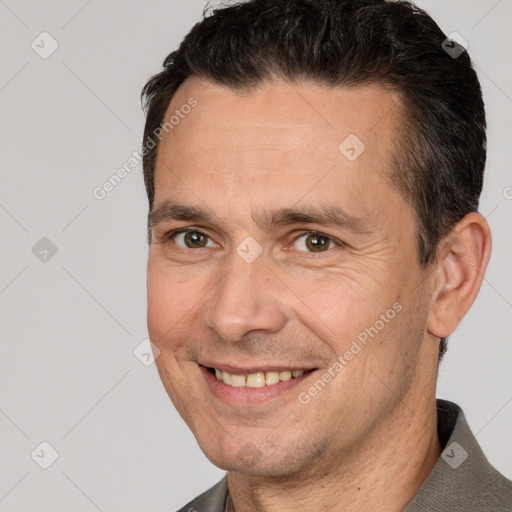 Joyful white adult male with short  brown hair and brown eyes