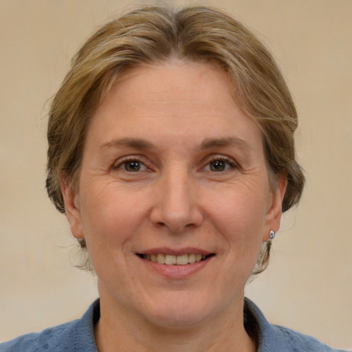 Joyful white adult female with medium  brown hair and grey eyes