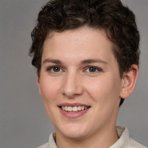 Joyful white young-adult female with short  brown hair and grey eyes