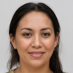 Joyful latino young-adult female with medium  brown hair and brown eyes