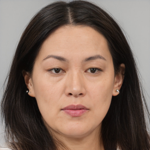 Neutral asian adult female with long  brown hair and brown eyes