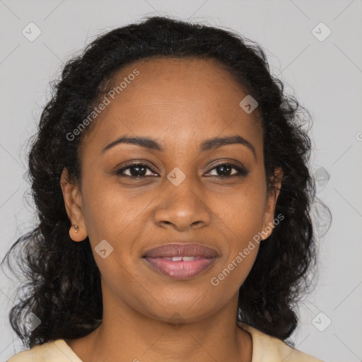 Joyful black young-adult female with long  brown hair and brown eyes