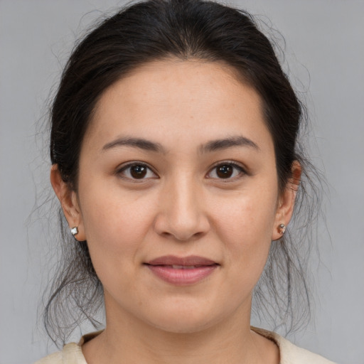 Joyful white young-adult female with medium  brown hair and brown eyes