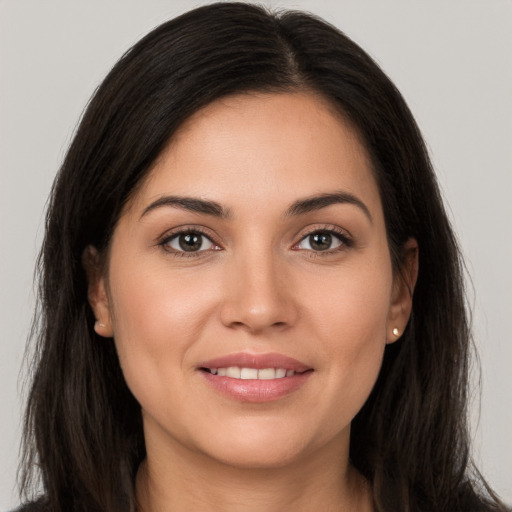 Joyful white young-adult female with long  brown hair and brown eyes