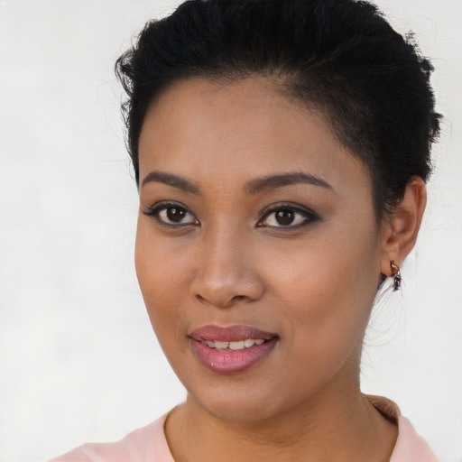 Joyful latino young-adult female with short  brown hair and brown eyes
