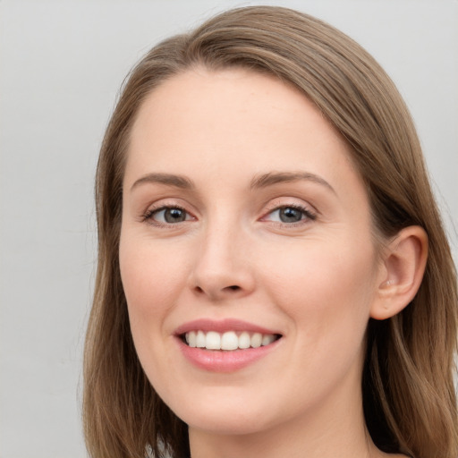 Joyful white young-adult female with long  brown hair and blue eyes