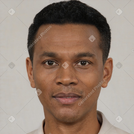 Joyful black young-adult male with short  black hair and brown eyes