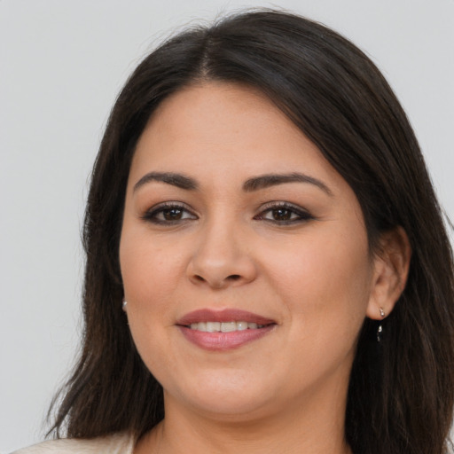 Joyful latino young-adult female with long  brown hair and brown eyes