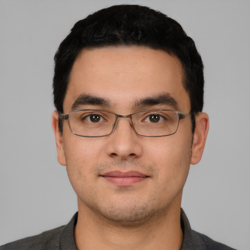 Joyful white young-adult male with short  black hair and brown eyes